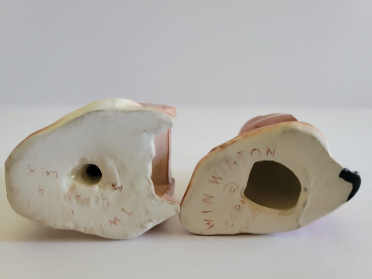 Bottom of two ceramic figurines.