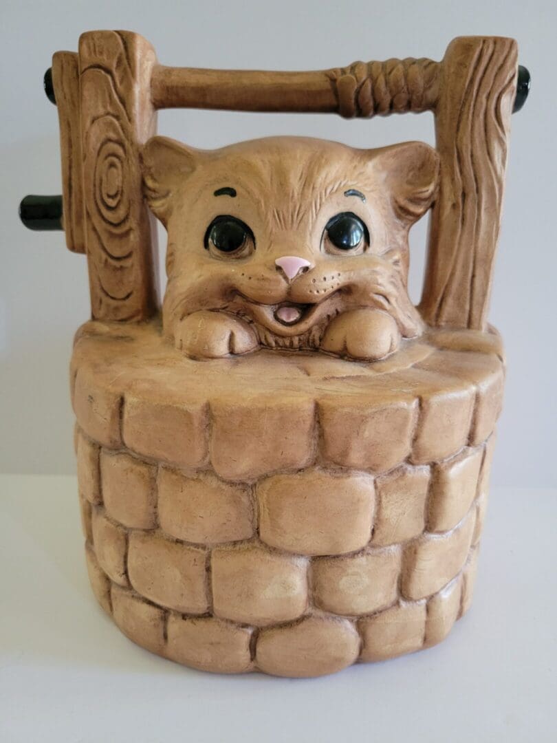 Ceramic cat figurine in a well.