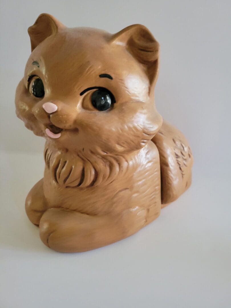 Brown ceramic kitten figurine with big eyes.