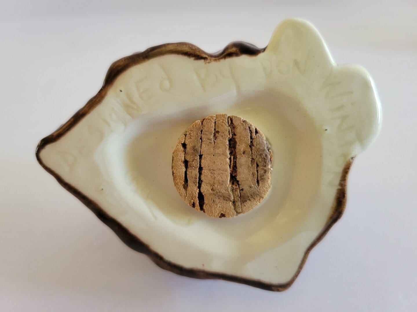 Cork stopper in a ceramic dish.