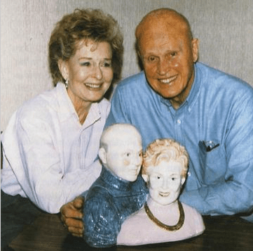 Couple with ceramic figurines of themselves.