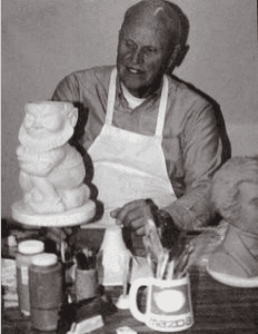 Black and white photo of a man sculpting.