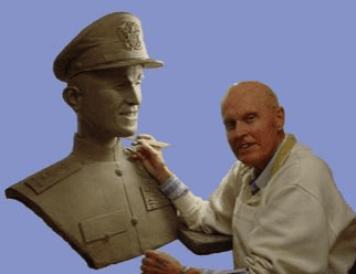 Sculptor working on a bust of a man.