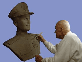 Sculptor working on a bust of a soldier.