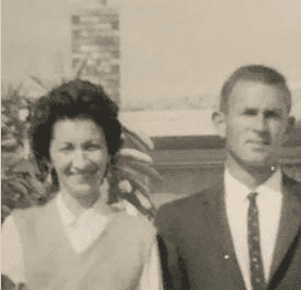 A smiling couple in a black and white photo.