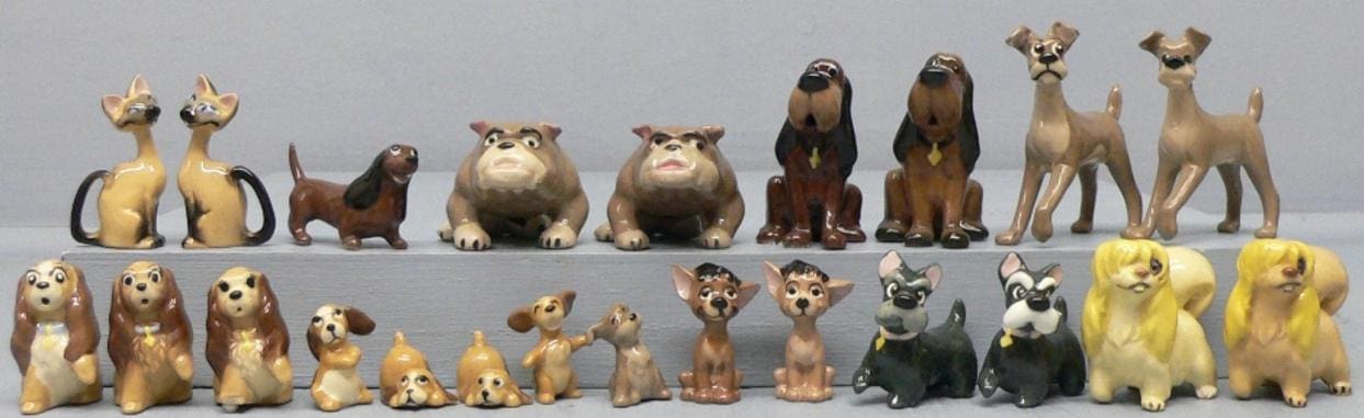 Ceramic Disney dog figurines on display.