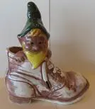 Ceramic gnome figurine in a boot.