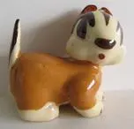 Ceramic figurine of a brown and white dog.