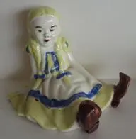 Ceramic figurine of Alice in Wonderland.