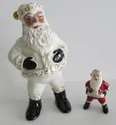 Two ceramic Santa Claus figurines, one larger.