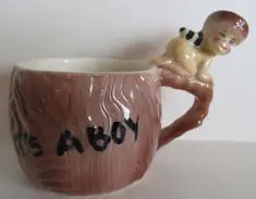 Ceramic mug with a boy on a branch.