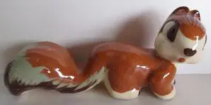 Ceramic squirrel figurine with brown fur.