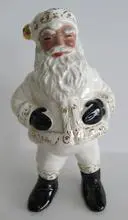 White porcelain figurine of a Black Santa Claus.