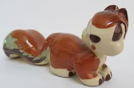 Brown and white ceramic squirrel figurine.