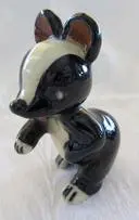 Black and white ceramic badger figurine.