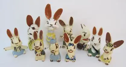 A group of ceramic bunny figurines.