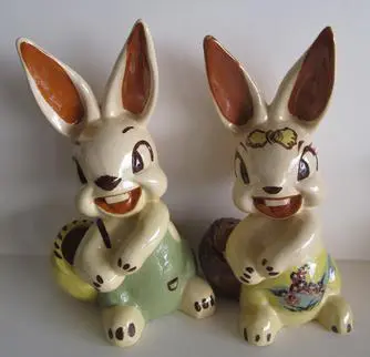 Two ceramic bunny figurines with baskets.