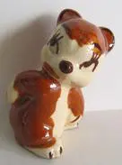 Ceramic figurine of a brown and white dog.