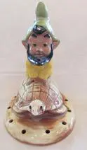 Ceramic gnome figurine on a turtle base.