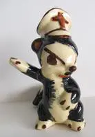 Ceramic figurine of a skunk in a hat.