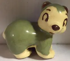 Green and yellow ceramic figurine of a bear.