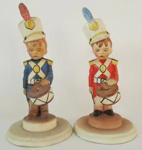 Two porcelain figurines of toy soldiers.