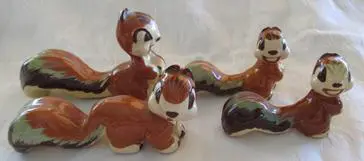 Four ceramic squirrel figurines