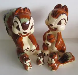 Four ceramic chipmunk figurines in various sizes.