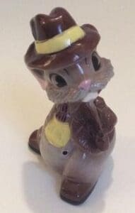 Brown ceramic figurine of a squirrel in a hat.