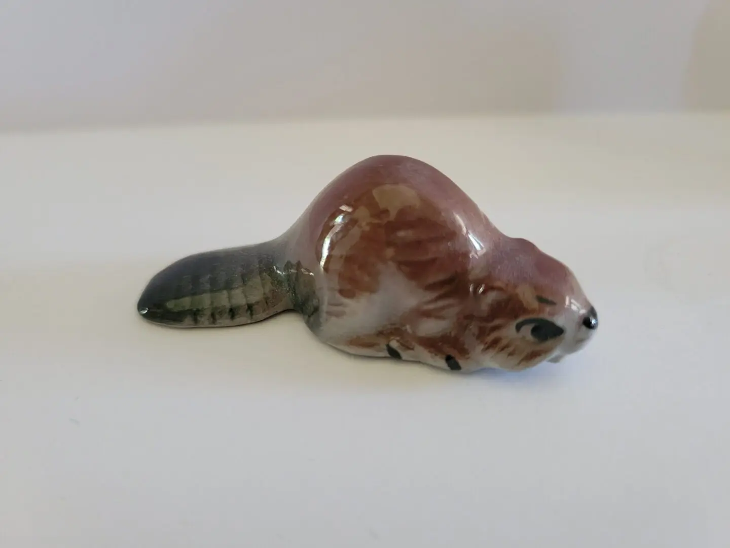 Small ceramic figurine of a beaver.