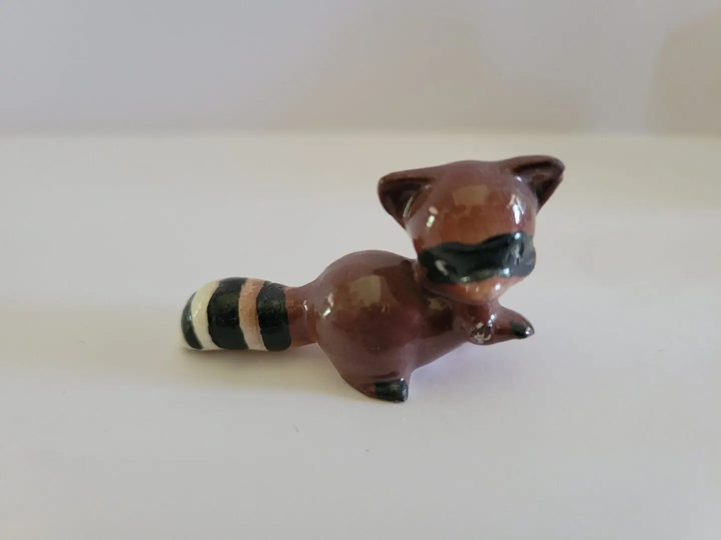 Ceramic figurine of a raccoon.