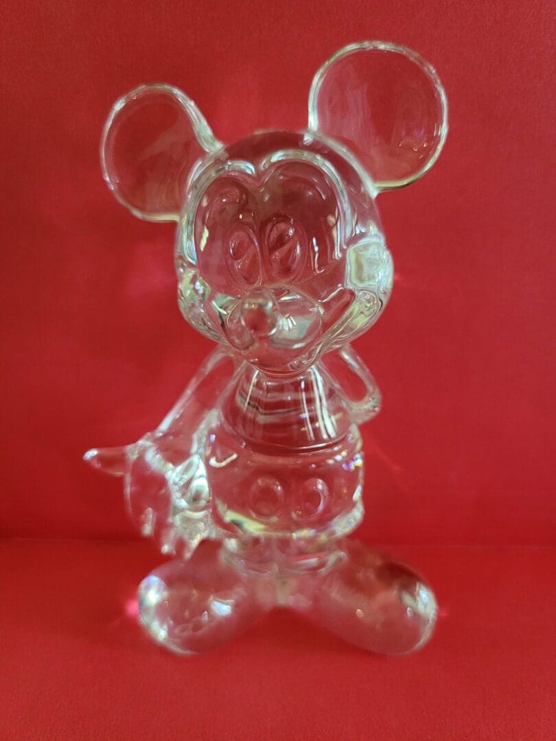 Clear glass Mickey Mouse figurine.