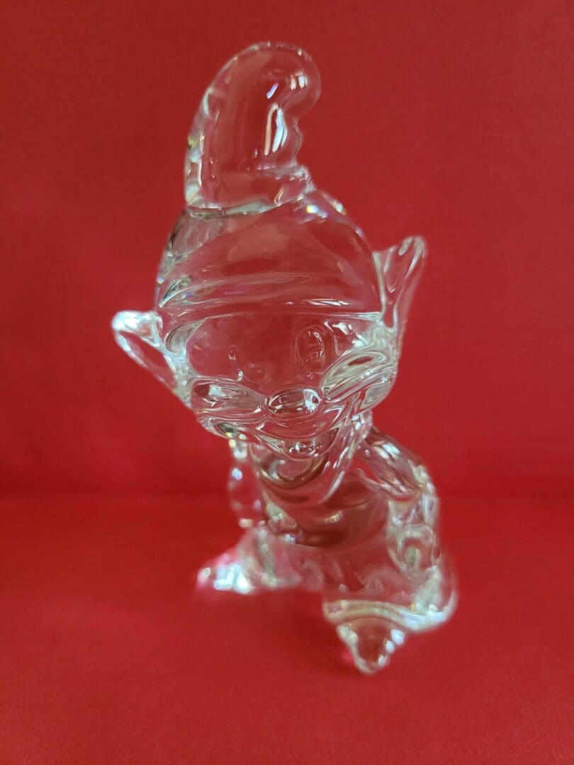 Crystal elf figurine on red background.