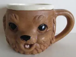 Brown ceramic mug shaped like a dog.