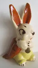 Ceramic bunny figurine with brown and yellow accents.