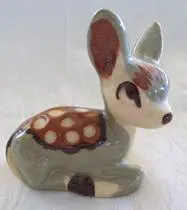 Ceramic fawn figurine with brown and white spots.