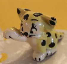 A small ceramic figurine of a leopard.