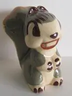 Ceramic figurine of a smiling squirrel.