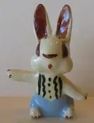 Ceramic rabbit figurine with blue pants.