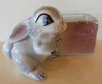 A white rabbit planter with a pink nose.