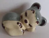 Ceramic figurine of a sleeping bear.