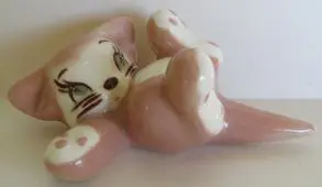 Pink ceramic kitten figurine with big eyes.