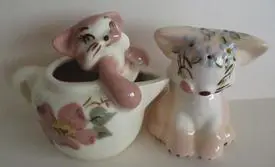 Ceramic salt and pepper shakers shaped like cats.