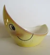 Yellow crescent moon shaped ceramic bowl.