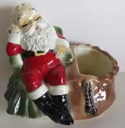 Sleeping Santa figurine with a sack.