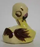 Yellow ceramic duck figurine with brown wings.