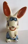 Hand-painted ceramic bunny figurine with blue eyes.