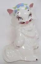 White porcelain figurine of a cat.