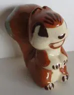 Ceramic squirrel figurine with brown and white glaze.