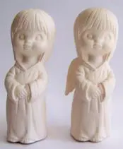 Two white porcelain angel figurines.